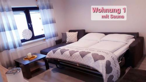 诺德代希Ferienhaus Blütenzauber in Norddeich的一间卧室设有一张大床和一个窗户。