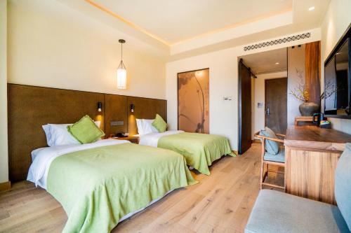 南京南京溧水中山湖金陵文璟酒店的酒店客房,配有两张带绿床单的床