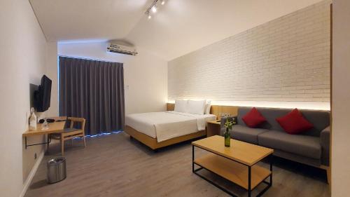 雅加达Ra Inn Kemang的酒店客房,配有床和沙发