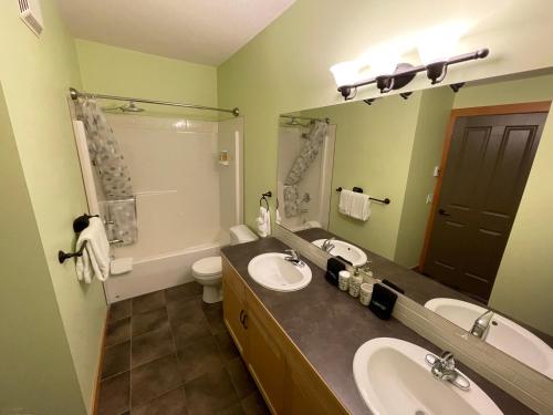 坎莫尔Renovated Condo, 2BR, 2BA, Heated Pool, 3 Hot Tubs, Pets Welcome!的浴室设有2个水槽、卫生间和镜子。