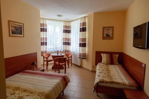 达洛科达罗科假日旅馆的酒店客房设有两张床和一张桌子。