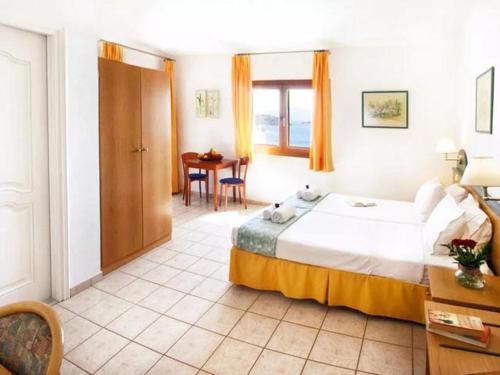 梅加利阿莫斯Fiorella Sea View的酒店客房设有一张大床和一张桌子。
