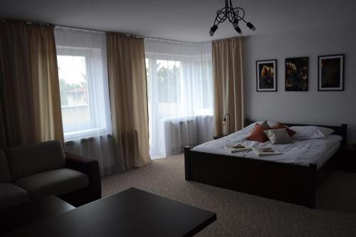 卡利什Apartament Szaława的一间卧室配有一张床、一把椅子和一张桌子