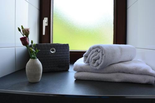 科赫姆Ferienwohnung Traumzeit的浴室提供2条毛巾和花瓶