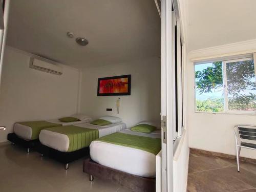 比亚维森西奥Confort Plaza Hotel的带窗户的客房内设有两张单人床。