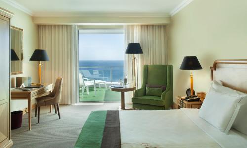 卡斯卡伊斯卡伊斯米拉格健康及Spa水疗酒店的酒店客房设有一张床、一张书桌和一个阳台。