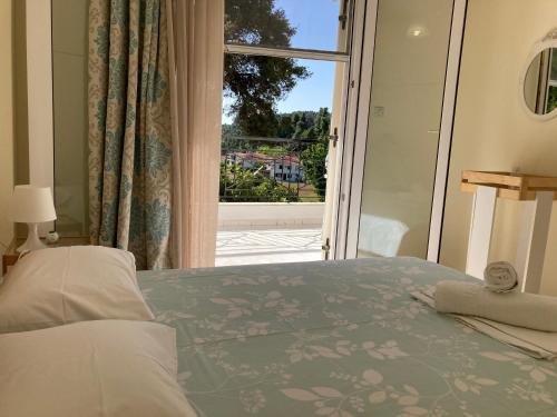 卡桑德里亚Villa Elani的一间卧室设有一张床和一个大窗户