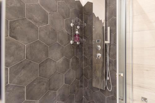 维拉西米乌斯Domu Ajaju Guest House的浴室设有六角形瓷砖和淋浴。