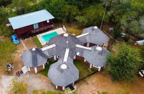 玛洛斯帕克Nanisto Bush Lodge的享有带游泳池和遮阳伞的房屋的空中景致