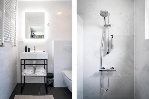 德科克斯多普Hotel het Anker van Texel的带淋浴和盥洗盆的白色浴室