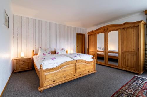 比苏梅尔代肖森Ferienwohnung von Postel的一间卧室设有一张大型木床和一个窗户。