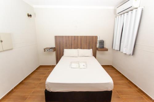 圣保罗Hotel Jabaquara Imiggrantes - By UP Hotel - Metro Jabaquara - 2KM Expo São Paulo的一张位于小客房内的床铺,配有白色床垫