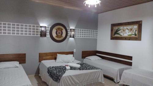 诺布里斯Pousada Rota das Águas的一间客房内配有两张床的房间