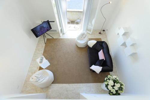莱切Luxury House Lecce -Le mie 3 Suites-的享有带白色家具的客厅的顶部景色。