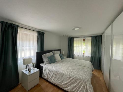 希明格Ferienwohnung Siglreitmaier 2的一间卧室配有一张带绿色窗帘的大床