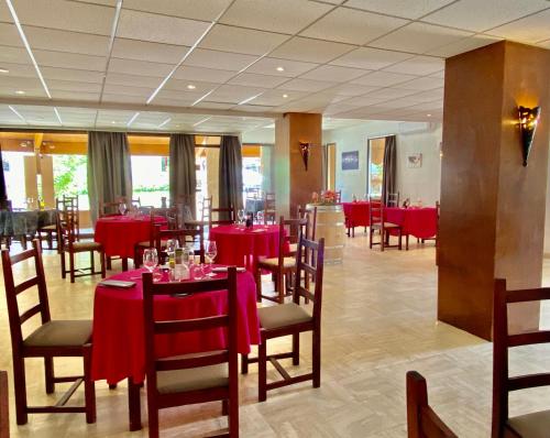 巴布通莱班 德拉派克斯酒店的一间设有红色桌椅的用餐室