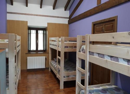 卡马莱尼奥Albergue La Vargona的房屋内带几张双层床的房间