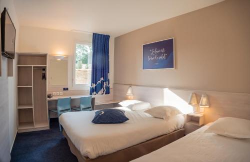 Le Petit-CouronneACE Hôtel Rouen Parc des Expositions的酒店客房配有两张床和一张书桌