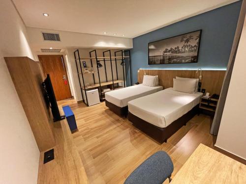 维多利亚Hotel Senac Ilha do Boi的酒店客房设有两张床和电视。