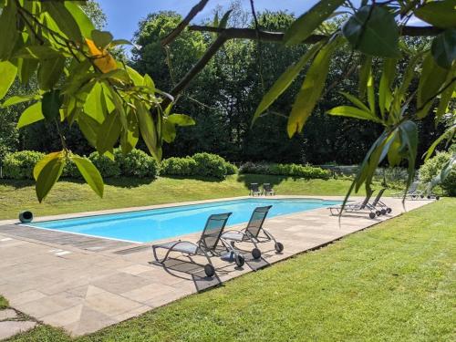 乌瑞基尼亚图比城堡酒店的两把椅子和一个庭院内的游泳池