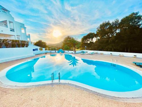 桑帕克Apartamento Brisa de Menorca的大楼前的大型蓝色游泳池