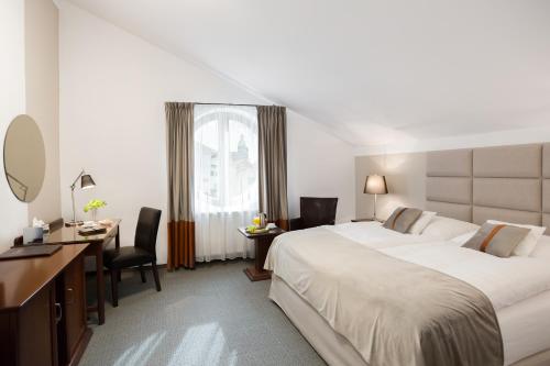 科希策布里斯托尔精品酒店的酒店客房设有一张大床和一张书桌。