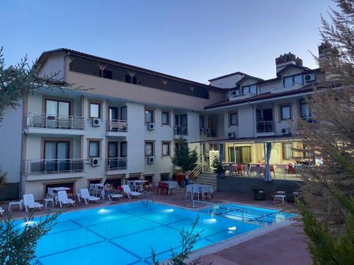 帕莫卡莱Mucize Termal Spa的大楼前设有游泳池的酒店