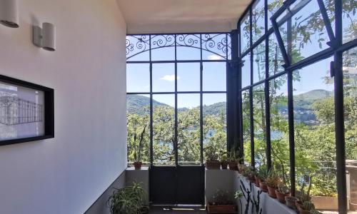 科莫Veranda lake view的客房设有带植物的大窗户。