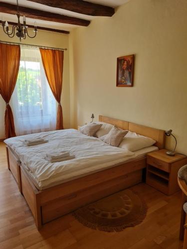 TvarožnáAndrišov dom penzion的卧室设有一张大木床,位于窗户前