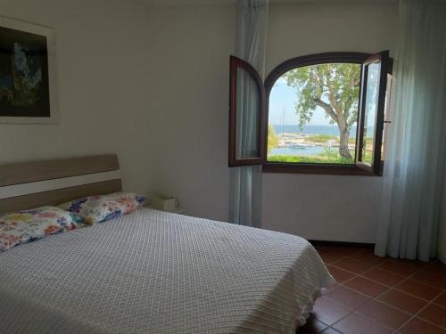 圣特奥多罗Casa Francesca Puntaldia的一间卧室设有一张床和一个开放式窗户。