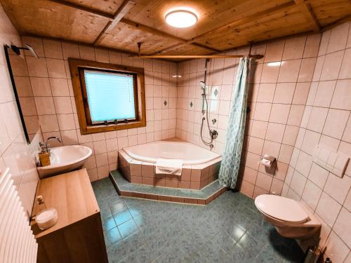 菲尔根Ferienhaus Berger的带浴缸、卫生间和盥洗盆的浴室