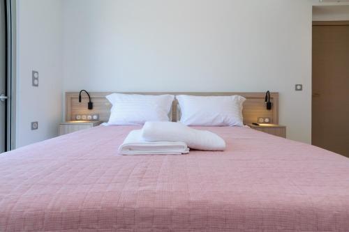 干尼亚Katakis LuxuryVillas的粉红色的床,上面有两个枕头