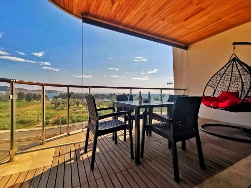 巴尔New Luxury Apartments BaR的阳台配有桌椅和大窗户。