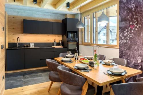 博希尼Hiša Križaj的厨房以及带木桌和椅子的用餐室。