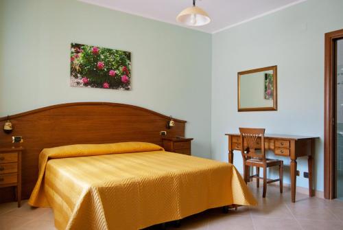 斯坎诺安吉拉住宿加早餐旅馆的卧室配有1张床、1张桌子和1把椅子