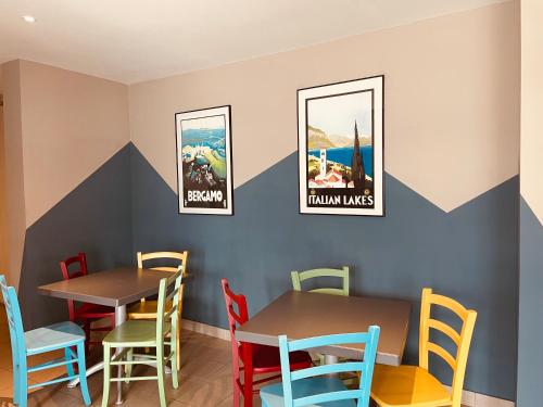 洛韦雷奥斯特罗德尔珀尔托酒店的用餐室配有2张桌子和五颜六色的椅子