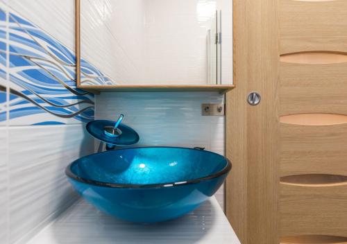 比托姆Błękitny Apartament的一个带蓝色碗水槽的柜台浴室
