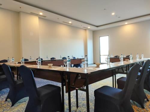 TobadiSuni Hotel and Convention Abepura managed by Parkside的大型会议室,配有长桌子和椅子