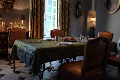 Grainville-YmauvilleChâteau de Trébons的一间带桌椅和窗户的用餐室