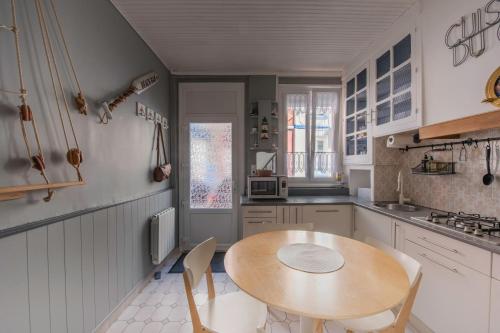 勒特雷波尔Maison de pêcheur LE TREPORT "ça nous va"的厨房配有木桌和椅子