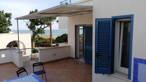 丽都玛里尼SPELU - Appartamento con terrazza fronte mare的阳台设有蓝色百叶窗,享有海景。