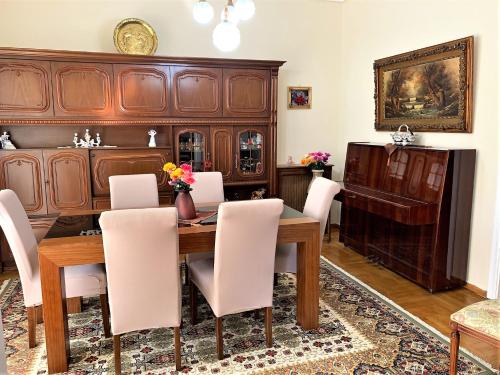雅典HIGH QUALITY 110qm 2BR at Simos-Lux-Apartment的一间带木桌和白色椅子的用餐室