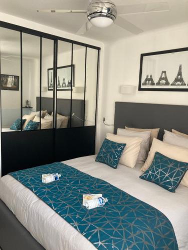戛纳戛纳市住宿加早餐旅馆的一间卧室配有一张带蓝白色枕头的大床