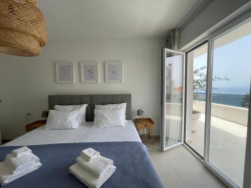 萨瓦拉Exclusive 2 Bedroom Seafront Suite with jacuzzi的一间卧室配有带毛巾的床