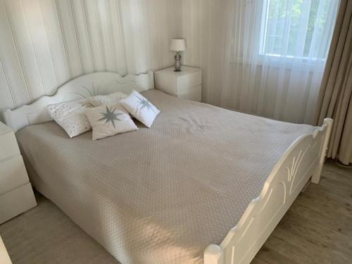 KontulaVilla Terveenniemi的卧室内的一张带枕头的白色床