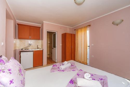 乌尔齐尼Guest House Edita的客房配有一张带紫色枕头的床。