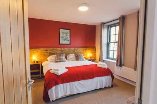 克雷迪顿Union Road Moto Velo Accommodation的一间卧室设有一张红色墙壁的大床