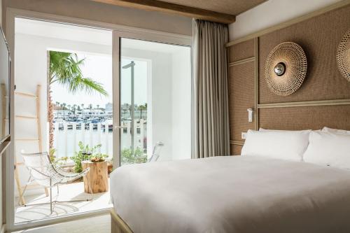 卡兰博希Lago Resort Menorca - Suites del Lago Adults Only的酒店客房设有一张床和一个阳台。