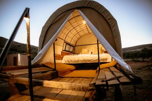 Somerset EastWitmos Oxwagoncamp的木制甲板上圆顶帐篷内的一张床位