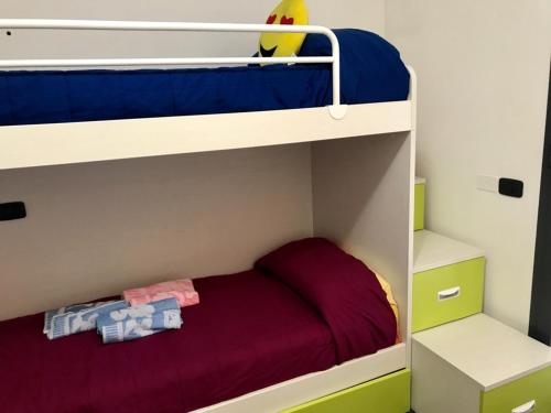 洛阿诺casa vacanza Carly的一张儿童双层床,上面有一张红色的床单